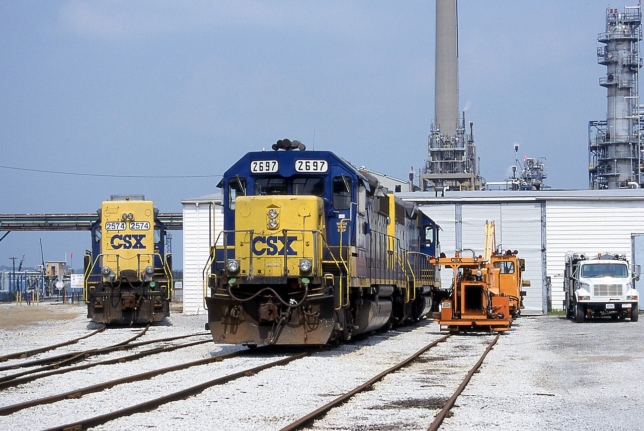 I thought this was a pretty standard-issue photo angle in Sarnia unit I looked at the aerial.  I don't think I'd venture this far off the public road for a shot nowadays.  Looking every bit like a shortline railroad's shop, the CSX shop area is quite quaint even if the industrial area surrounding it is far from it. Train D724 has just finished their work and CSXT 2697 and 2561 have been parked in front of the shop to wait for their next assignment.  The "bright future" paint scheme sure looks good now that the drab "dark future" scheme has taken over.  Chessie was better, but you've got to take what you get.