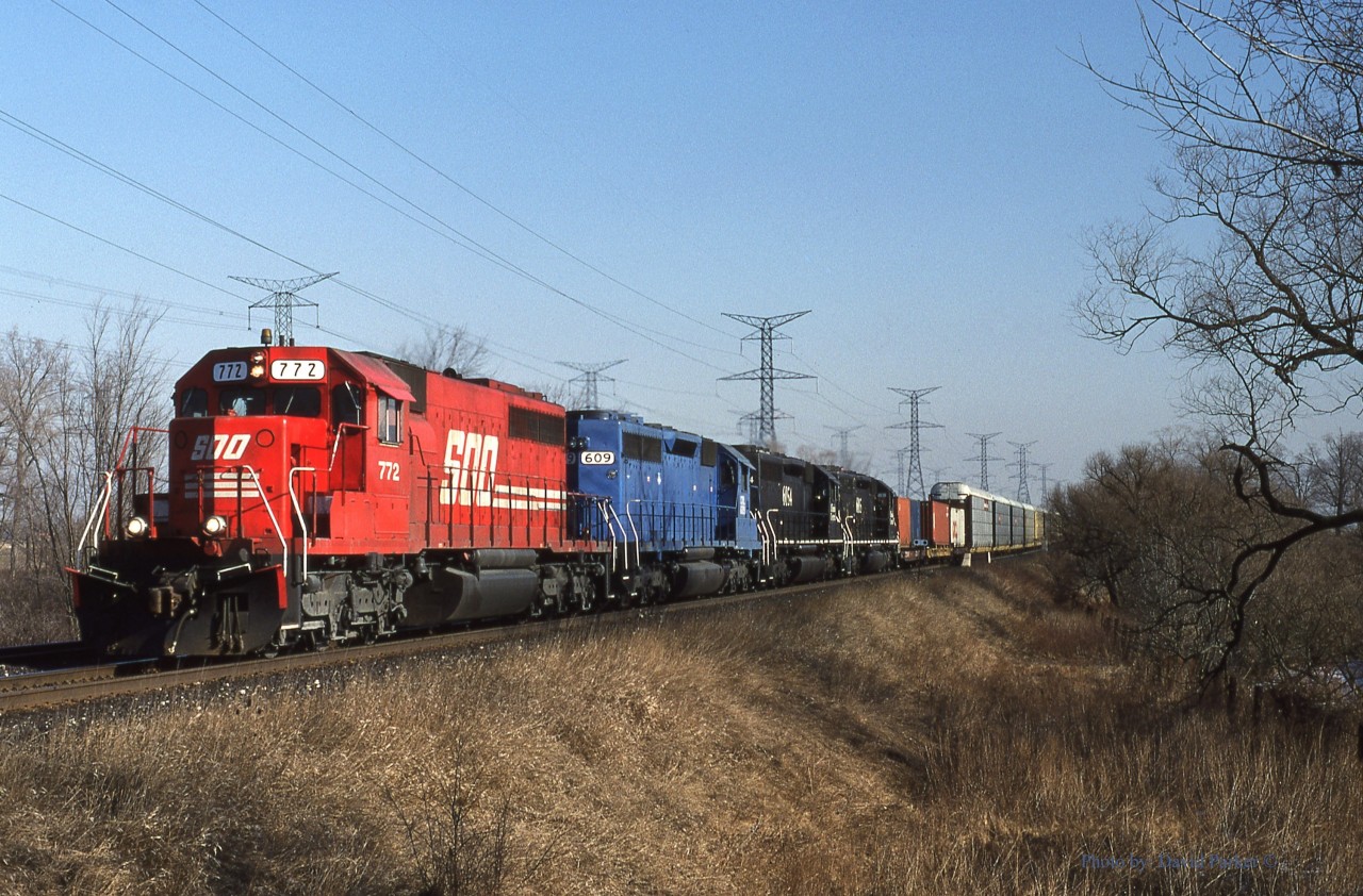CP 511-17 cruises down the "Hornby Dip" at the 6th Line crossing just East Of Milton, Ont with a colourful power consist during the rainbow/rent-a-wreck era. Feb 17th 1995.
