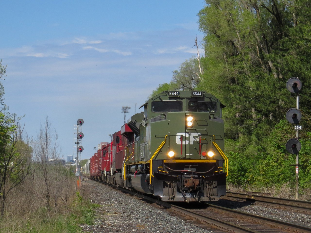 CP 2-421-24 hauls westbound through Leaside with CP D-Day commemorative locomotive 6644 leading the way. CP 8938, CP 3119, and CP 3134 trail. The 2 GP38-2s were dropped in Spence.