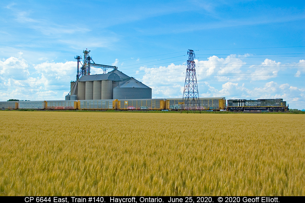 Soon to be "amber waves of grain"..........  CP SD70ACU #6644, in it's camouflage colors applied to Royal Canadian Air Force "Spitfire" fighter planes flown at the Allied invasion of Normandy, France, on June 6, 1944, rolls past the large grain elevator in Haycroft, Ontario on June 25, 2020.  Grain, grain elevators, and trains combined made Canada great, but sadly the railroad no longer services this mill and all product is now shipped by truck which is an all too common reality in this new millenium.