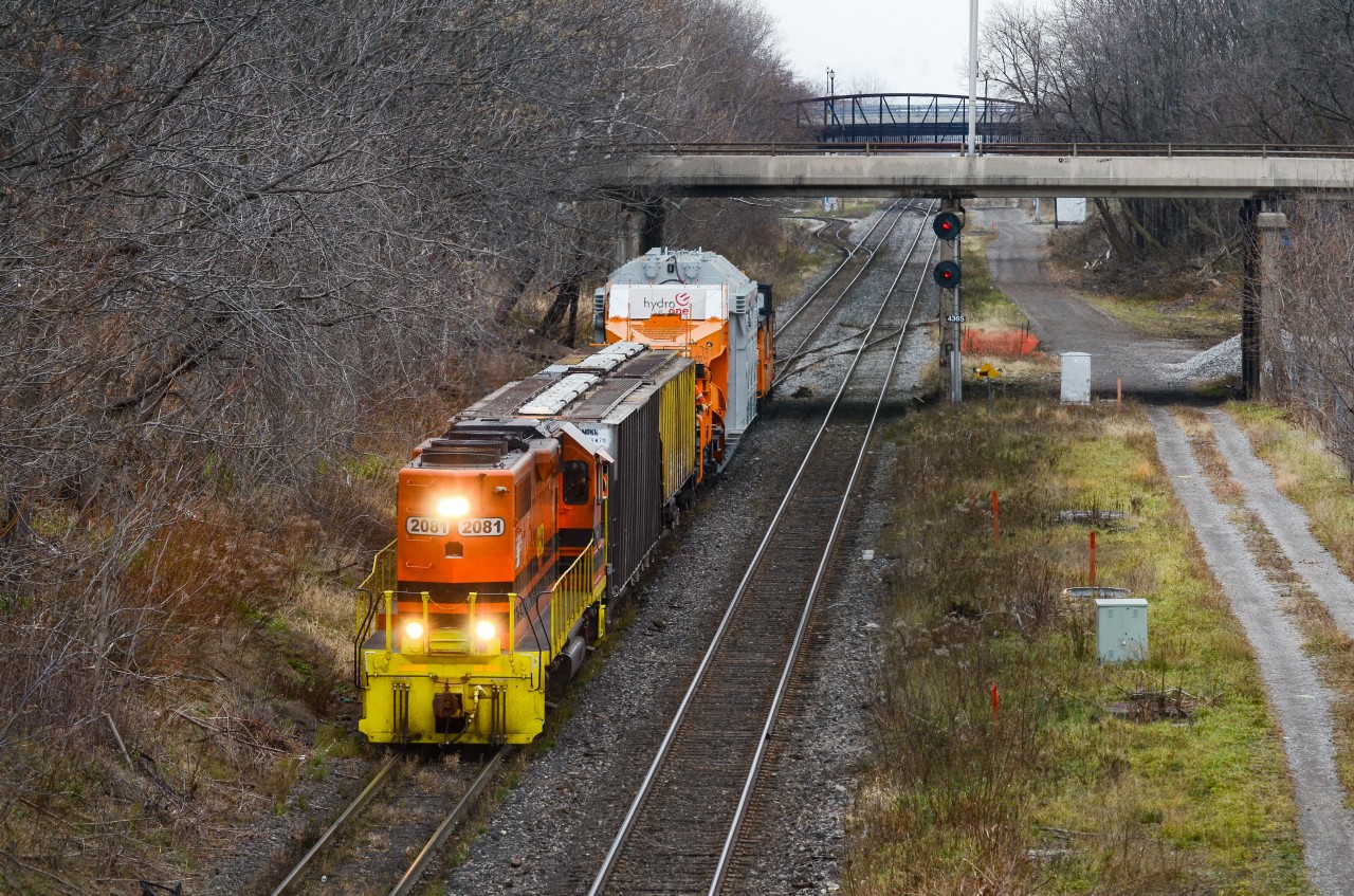 RLHH 2081 does the honours on cold gloomy day with less than ideal lighting conditions to bring a Hydro One transformer on the Schnable car to Hamilton Yard from the port destined to Pickering. About to pass under James St N, this D9R dimensional crawled from the N&NW Spur switch all the way to the yard with roughly a 10 man crew from Hydro One.