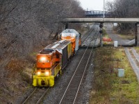 RLHH 2081 does the honours on cold gloomy day with less than ideal lighting conditions to bring a Hydro One transformer on the Schnable car to Hamilton Yard from the port destined to Pickering. About to pass under James St N, this D9R dimensional crawled from the N&NW Spur switch all the way to the yard with roughly a 10 man crew from Hydro One.