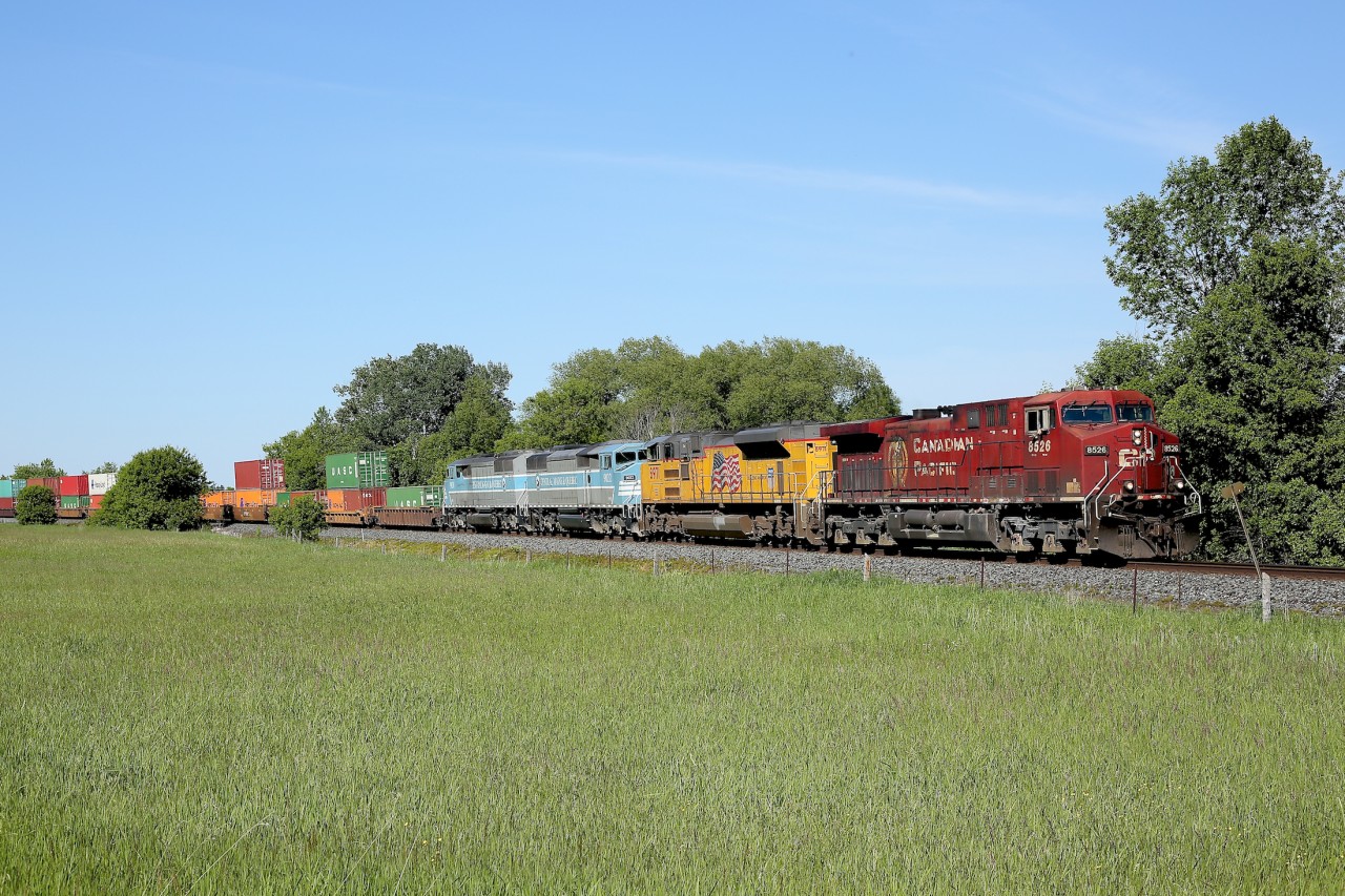 A colourful train 118 has cleared Baxter and passes by a field north of Alliston.  Nice to see the ex-red barns making a couple of appearances through here these past few days.
