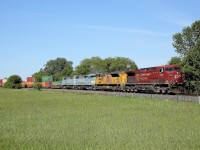 A colourful train 118 has cleared Baxter and passes by a field north of Alliston.  Nice to see the ex-red barns making a couple of appearances through here these past few days.  