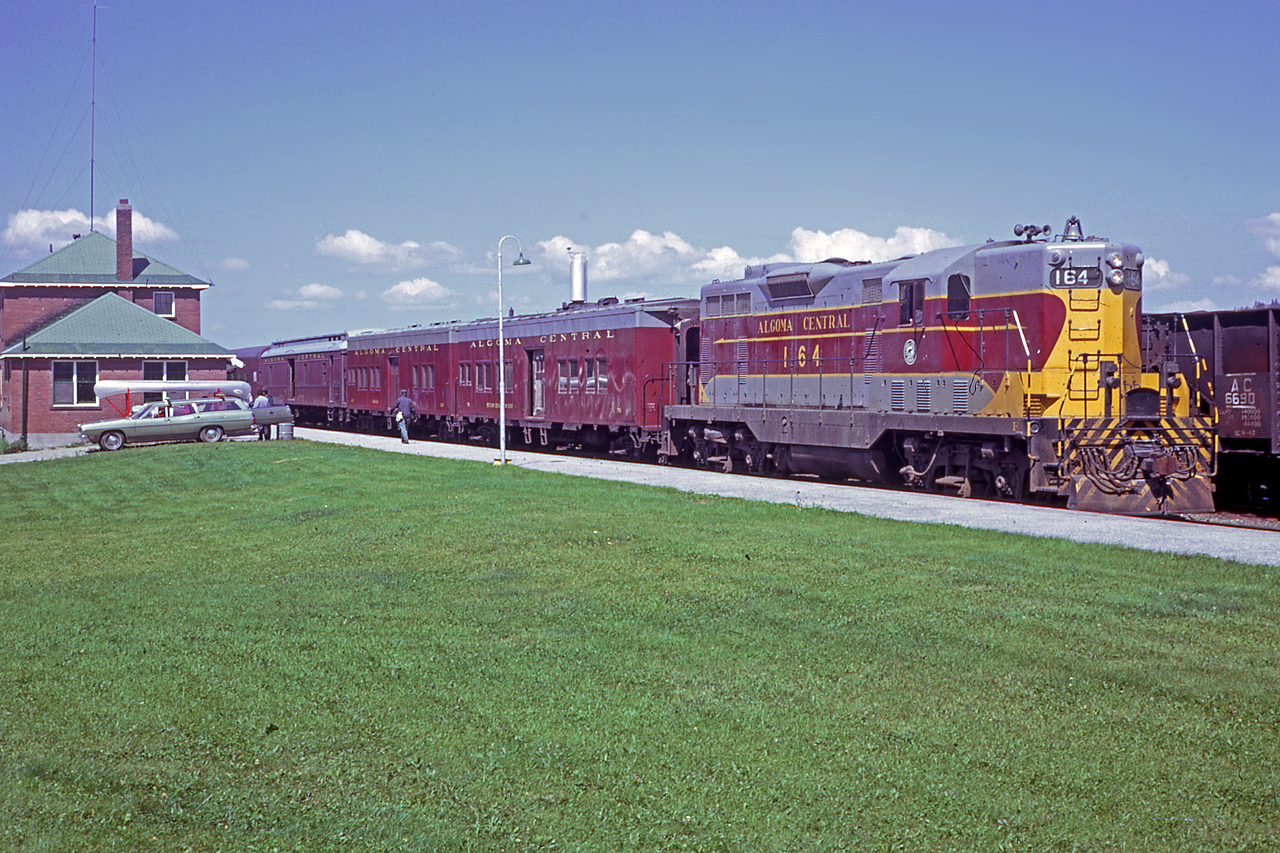 Algoma Central Railway GP7 164, built by GMDD in 1951, idles away at the Hawk Junction station on the head end of what is believed to be train number 2 (based off a 1974 timetable and approximate sun angle).  The southbound passenger train is bound for the Sault some 164 miles away.