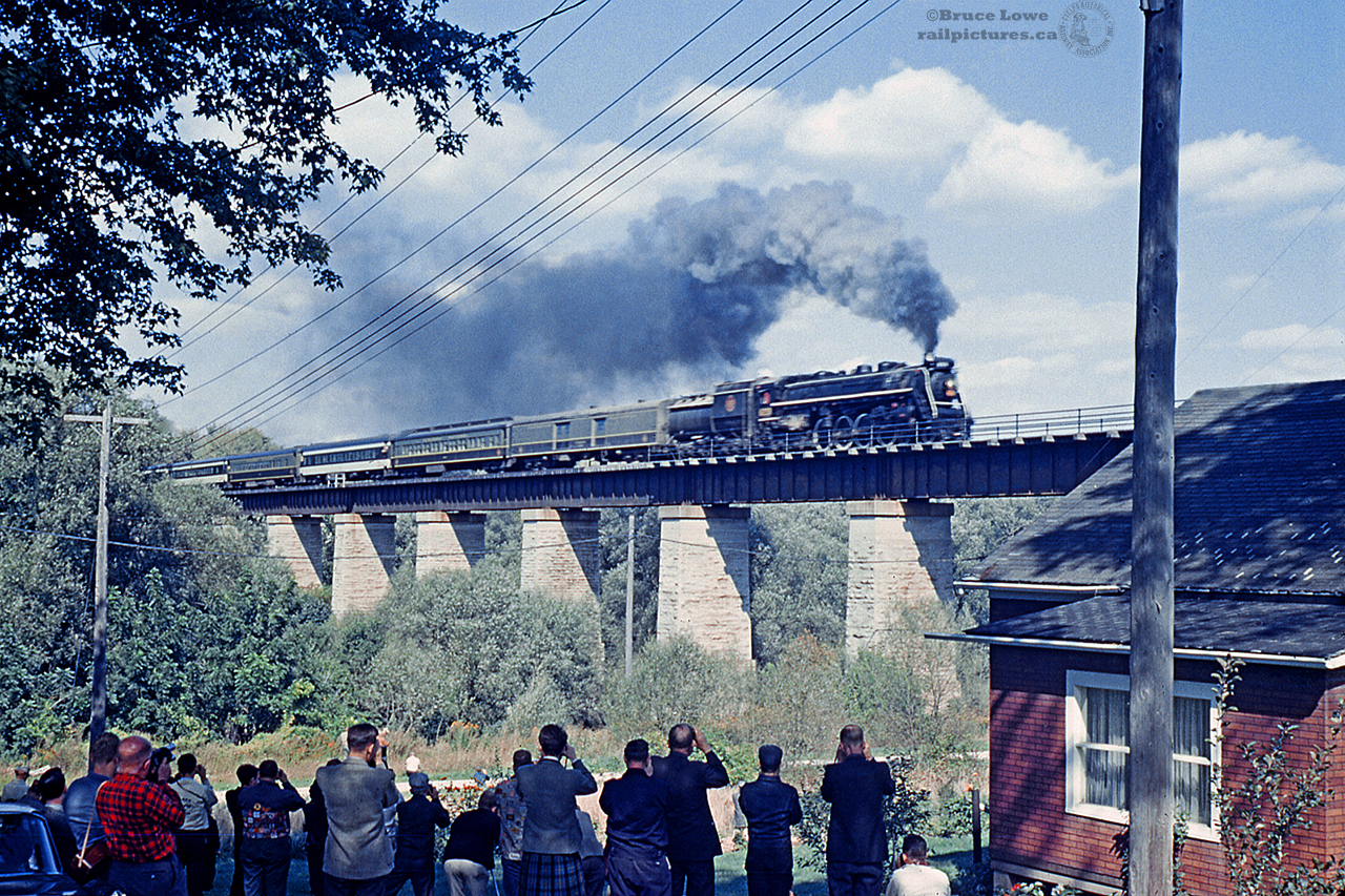 With railfans and townsfolk below, CNR 6218 blasts over the "London Bridge" atop Trout Creek, making it's runpast towards the station at St. Mary's Ontario during an excursion trip.  Now on display at Fort Erie, the 6218 has been receiving long overdue restoration efforts from the city, with plans to eventually erect a cover over the locomotive and caboose.
