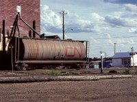 An elevator scene from the end of June, 1983. I took photos of all 3 elevators, with this being the best and of most interest. Every elevator has a single car spotted, with each one being different. Elevator 1, to the right in this photo, has a Trudeau hopper, elevator 3 has a grain box. The filling spout has been left in for the night on this CN hopper, with 2 more bays to fill tomorrow. The large elevators of today, with the long lines of cars being run through the loading dock, seem to have lost a little of the human and farm factor. In only a few years after this picture was taken, the lineups of farm trucks waiting to unload will be gone from Redwater. As well as the farmers and their families that would make a day of visiting and shopping at this busy time.