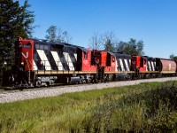 The grain extra has just passed through Redwater and will make a quick stop in Gibbons to pickup a string of empty flats. This will be the last bit of work they will do, Edmonton is only a short distance away. By this late in the 1988 summer, having pure GP9's for power was becoming uncommon. The GP38's had become the goto unit for heading up trains.