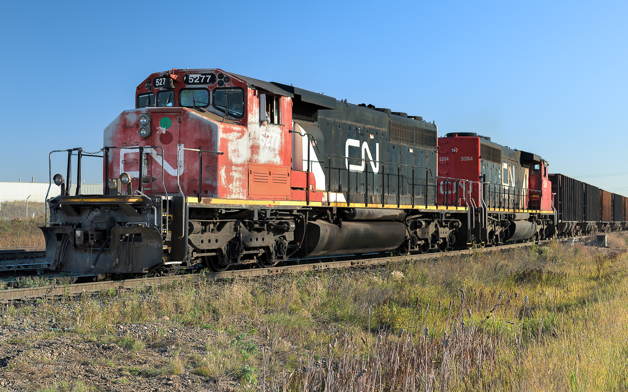 The eastbound they were waiting for has now passed. Next is to have the route lined up plus a light to proceed and the 5277 with a train of open top hoppers will leave Clover Bar behind.