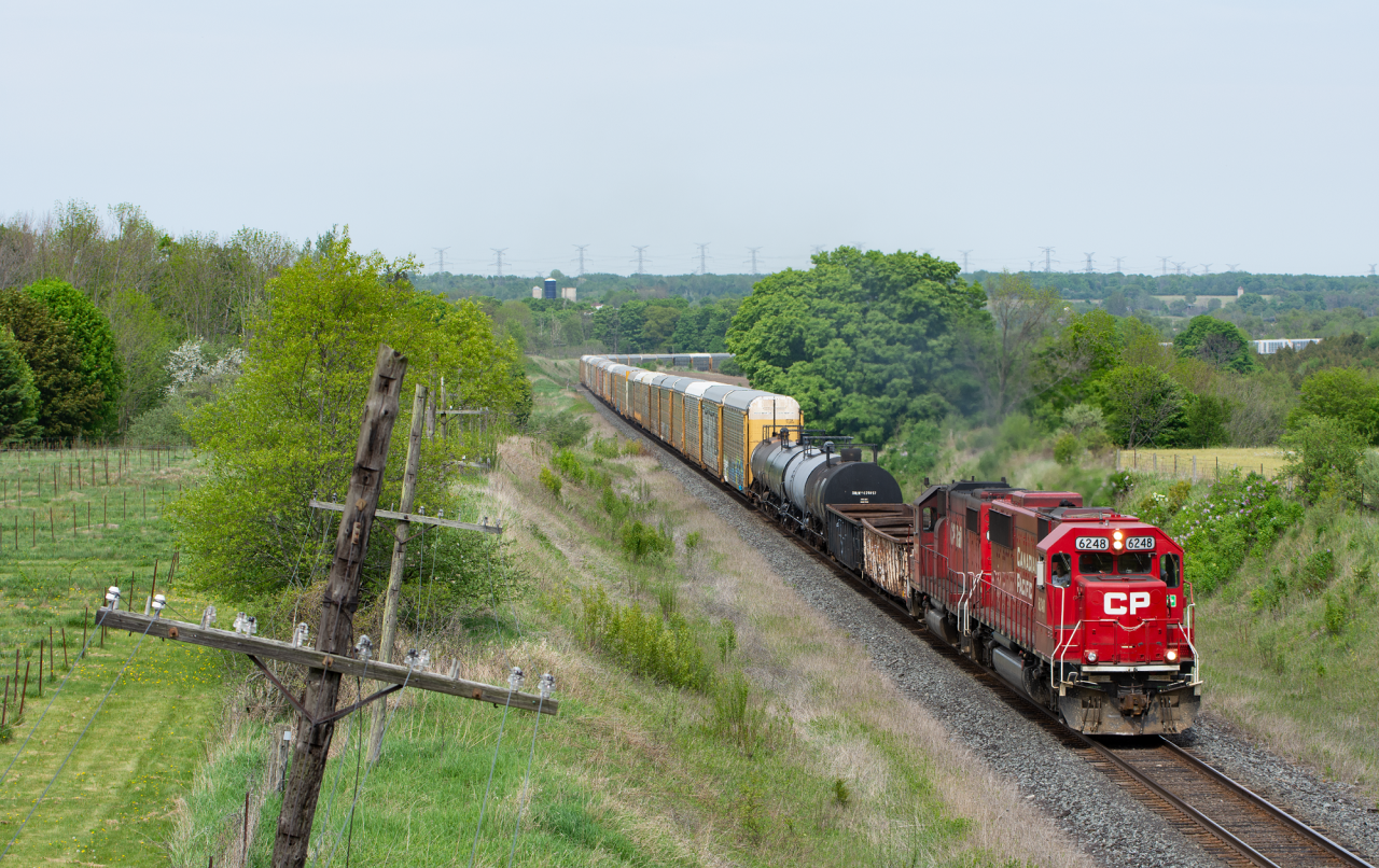 A pair of ex. SOO EMD's lead what I can only presume to be a T10 back to Toronto. I was out trackside with a friend when we got word from a buddy up the line that 6248 was leading a autorack movement out of storage. On their way they would grab T10's power and cars which were sitting in Trenton. It was sure a treat to see a solid EMD lashup on CP these days.