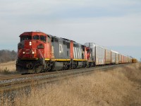 CN 434 rolls up the Halton Sub towards Lower Base Line south of Milton with a duo of "Draper Taper" Dash 8-40CMs #2430 upfront and #2425 trailing. Tagging along is a dead GP9RM #7230 coming up from Sarnia. The train in the background was a westbound auto train led by another pair of Dash 8s, but of the ex ATSF variant.