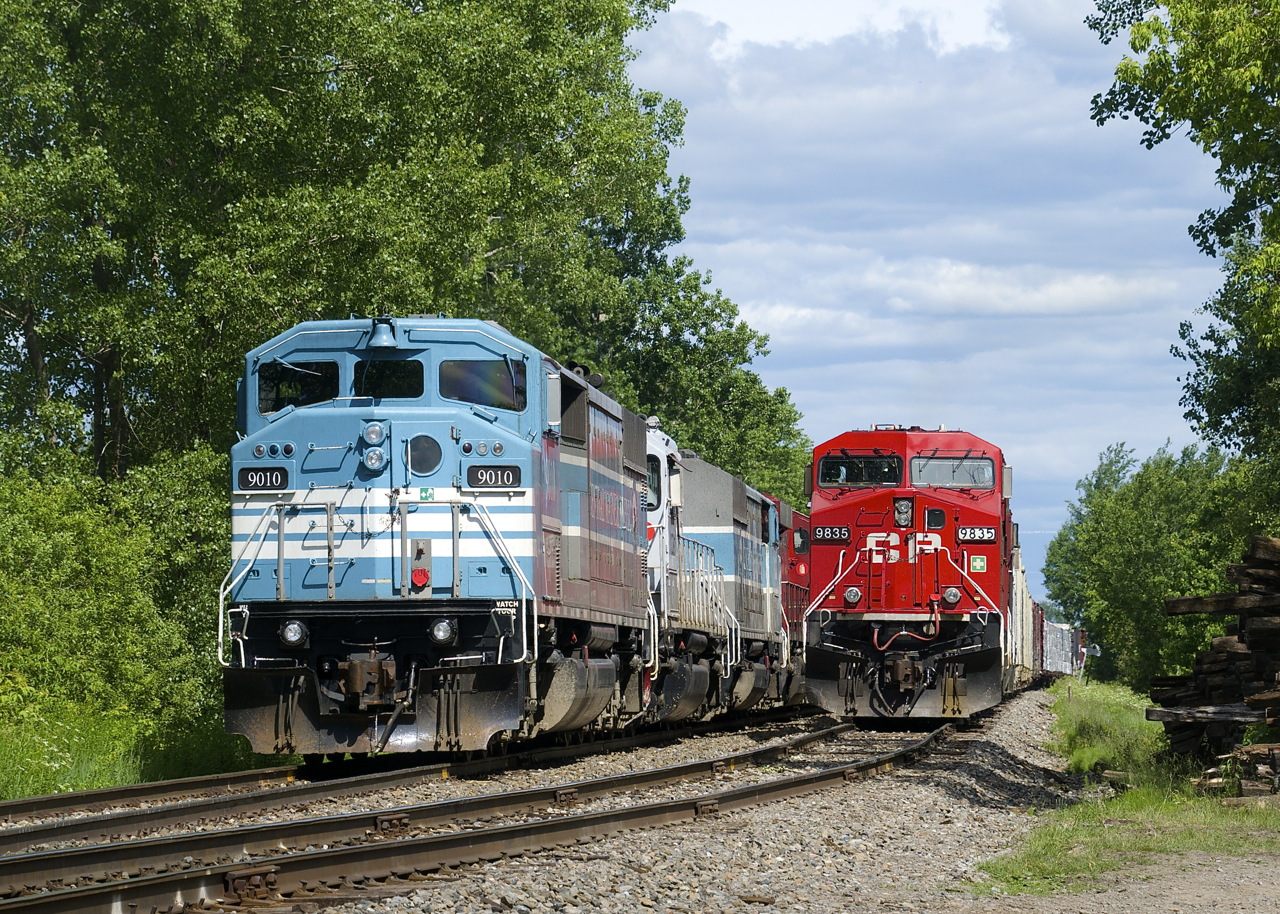 Two editions of CP 251 (formerly CMQ 1) are parked just west of Farnham. The one at left arrived on Saturday evening and has CMQ 9010 leading, the one at the right arrived early on Sunday morning and has CP 9835 leading. CP just completed its takeover of the CMQ last week.