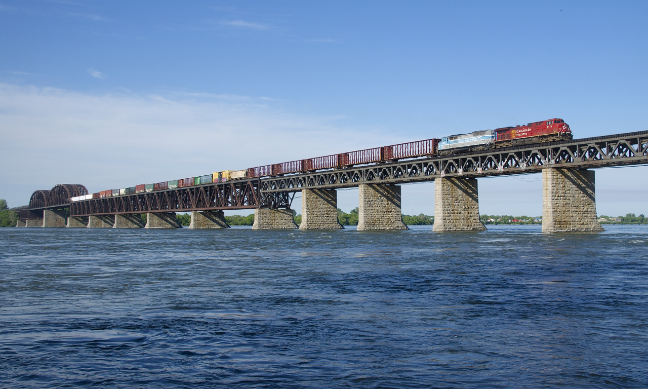 CP 253 has CMQ 9023 trailing CP 8113 as it approaches the island of Montreal on CP's impressive bridge that spans the St. Lawrence River.