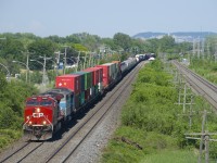 CP 119 with CP 8109 and CMQ 9023 is westbound through Pointe-Claire with its usual wide mix of traffic.
