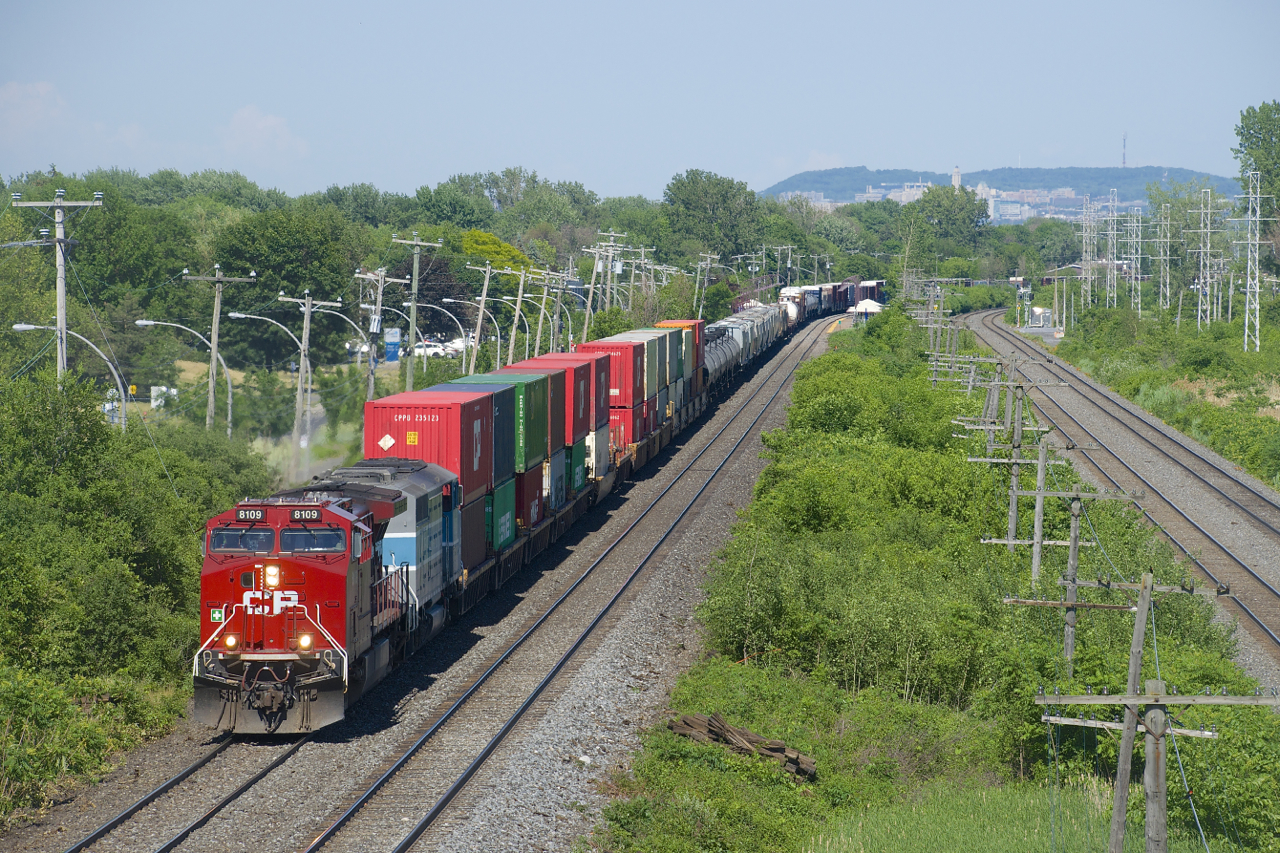 CP 119 with CP 8109 and CMQ 9023 is westbound through Pointe-Claire with its usual wide mix of traffic.
