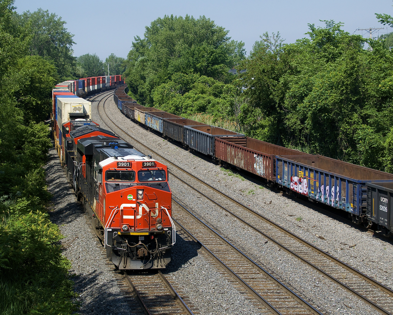 CN 120 has CN 3901 and CN 3142 for power and a 484-axle long train as it passes stored gondolas that are on the transfer track of CN's Montreal Sub. CN 3901 is a tier 4 credit unit that was delivered to CN towards the end of last year.