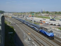 Ex-GO Transit F59PH AMT 1344 leads EXO 1207 for Mascouche past Turcot Ouest at MP 6.2 of CN's Montreal Sub. Until a couple of years ago CN's Montreal Sub was a few hundred metres further south of here. It was relocated to its present location due to an extensive highway reconstruction project which is finally nearly complete.