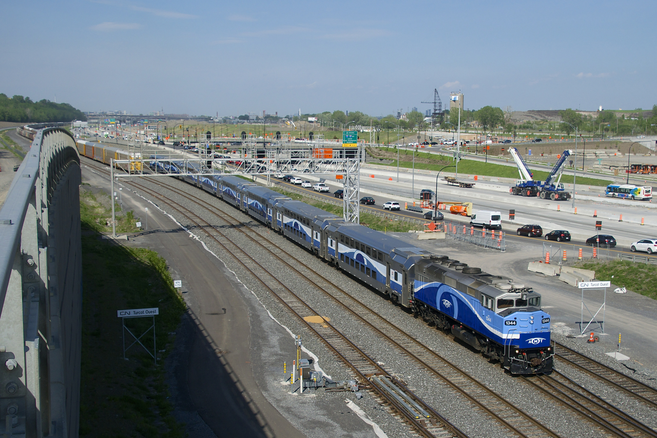 Ex-GO Transit F59PH AMT 1344 leads EXO 1207 for Mascouche past Turcot Ouest at MP 6.2 of CN's Montreal Sub. Until a couple of years ago CN's Montreal Sub was a few hundred metres further south of here. It was relocated to its present location due to an extensive highway reconstruction project which is finally nearly complete.