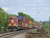 CP 143 has CP 8752, CP 9729 and 125 platforms as it passes MP 12 of CP's Vaudreil Sub.