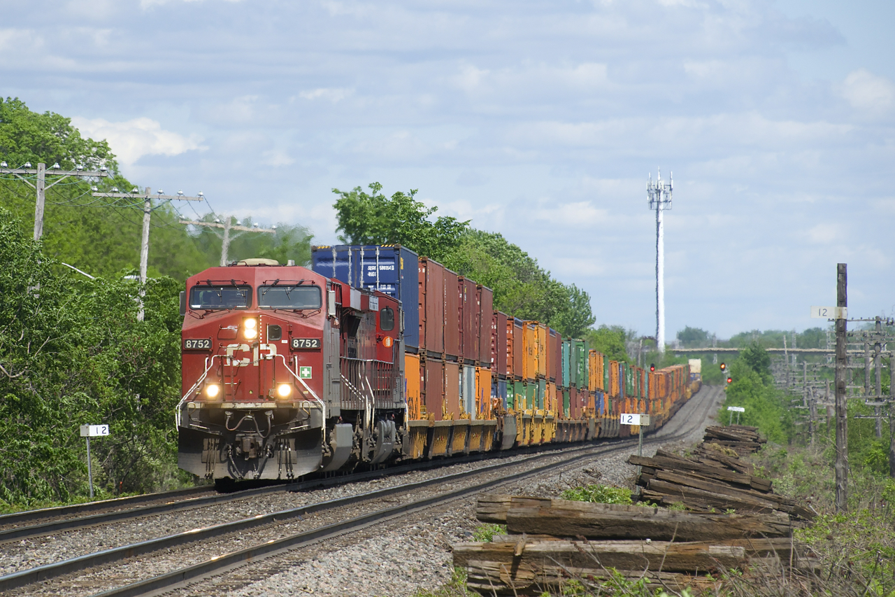 CP 143 has CP 8752, CP 9729 and 125 platforms as it passes MP 12 of CP's Vaudreil Sub.