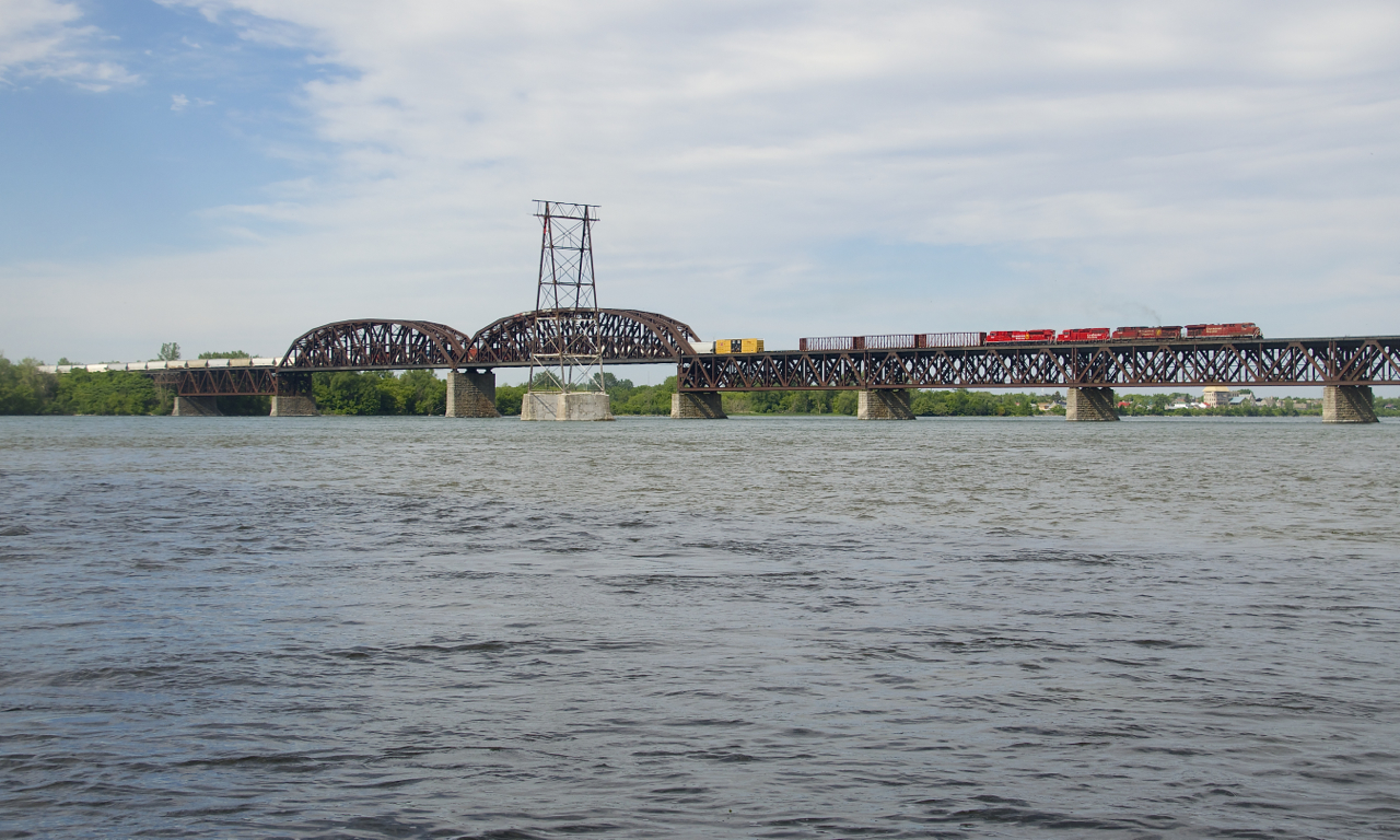 The second unit lets out some smoke as CP 253 crosses the St. Lawrence River with CP 8761, CP 9755, CP 2257 & CP 7038 for power.