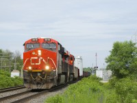 CN 351 heads west with a D9 dimensional load on a 16-axle flatcar (KRL 164003) as their second car and CN 3818 & CN 2953 for power. The load is a generator which is heading to the Pickering Nuclear Generating Station in Pickering, Ontario.