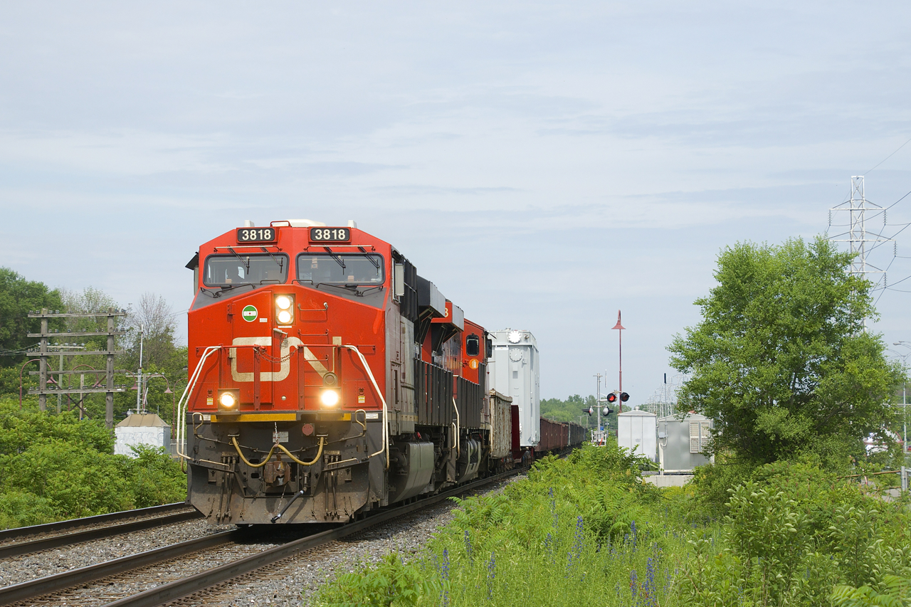 CN 351 heads west with a D9 dimensional load on a 16-axle flatcar (KRL 164003) as their second car and CN 3818 & CN 2953 for power. The load is a generator which is heading to the Pickering Nuclear Generating Station in Pickering, Ontario.