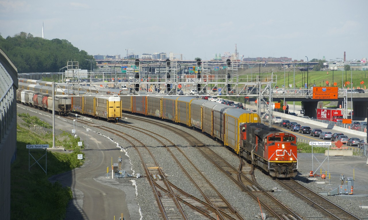 In what must surely be seen as a sign of the economy slowly starting to come back to life, CN X271 with CN 8830 and CN 5684 is passing Turcot Ouest with 110 empty autoracks, which had been stored in the St-Apollinaire siding at MP 20 of CN's Drummondville Sub. It is passing a long string of autoracks which are still stored on the freight track of CN's Montreal Sub. A CN 271 originating out of Taschereau Yard with more autoracks coming out of storage would run a couple of hours behind X271.