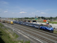 AMT 1344 leads EXO 1207 past autoracks and grain cars which are on the freight track and track 29 of CN's Montreal Sub respectively as it approaches Turcot Ouest.