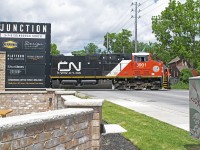 CN 533 makes a rather uncommon daylight appearance in Guelph. Passing the really well done "The Junction" building on Edinburgh Road in Guelph. 