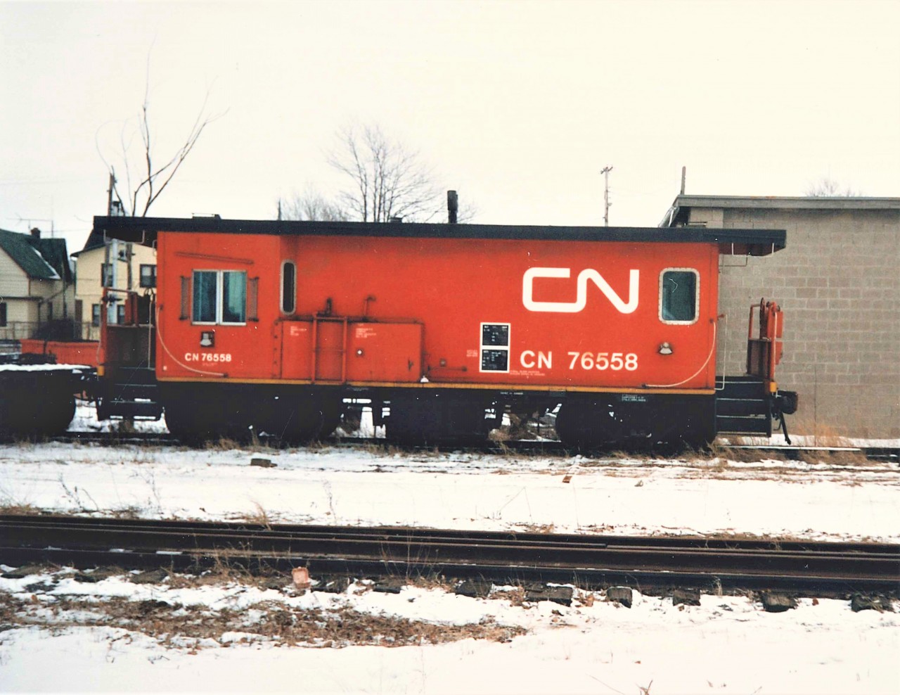 CN Burro Crane 50357 is separated from Transfer Van 76558 by a flat car.  The Van sits at the Welland St. Spur that connected off the Humberstone Sub just west of Bell St. and was the location of the then new CN General Cargo loading dock.  This type of dedicated rail bound MOW equipment would eventually be replaced by BRANDT equipment on most lines.