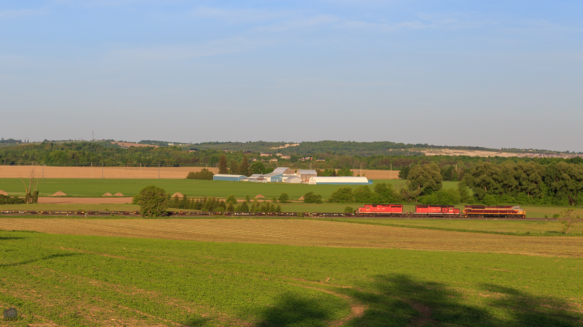 CP train CWR-04 rolls through the countryside of Baxter, with a trio of GMD/EMD units featuring 2 different generations of CPR paint schemes.