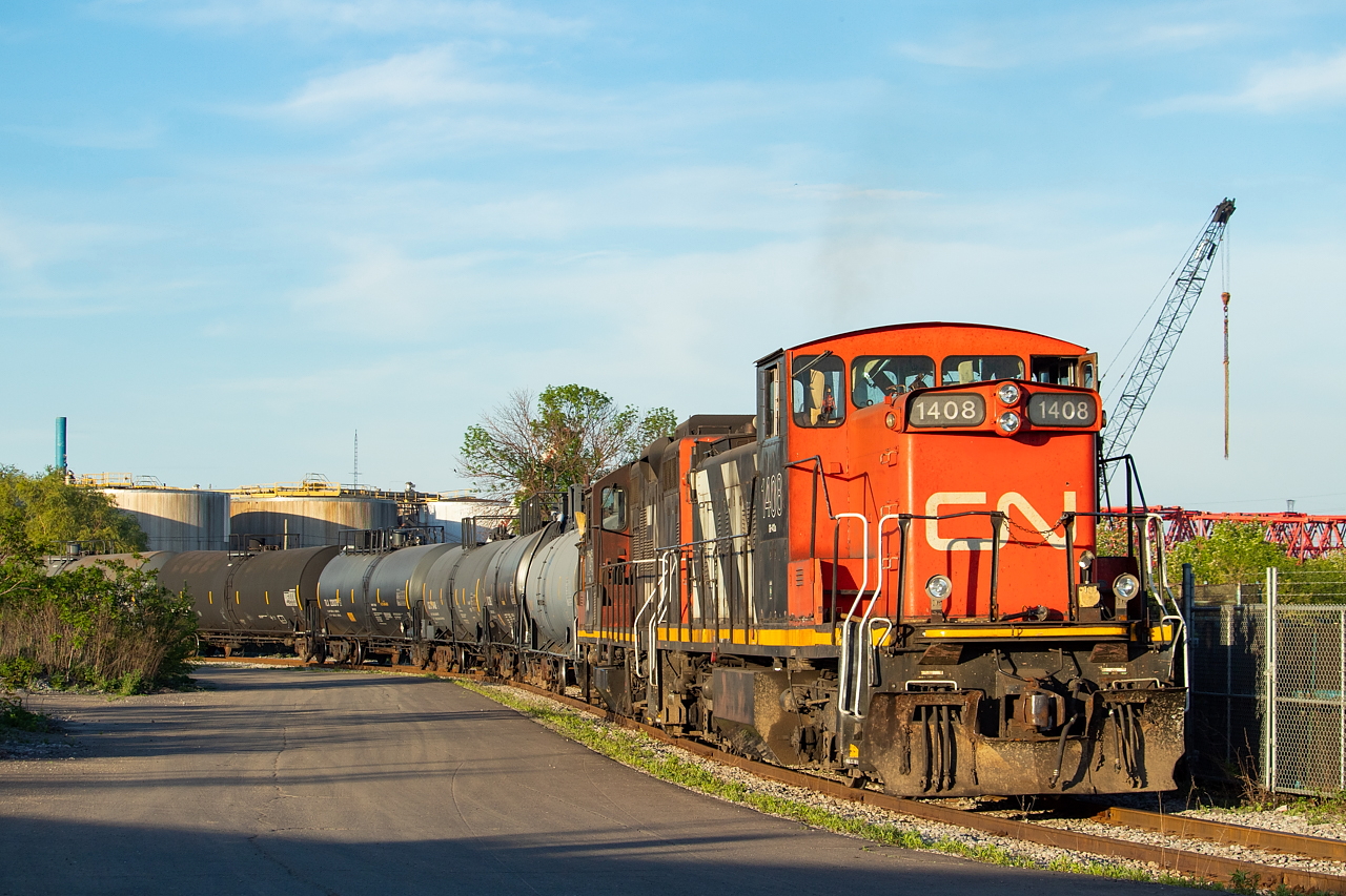 1408 is on point as the 1600 Yard Job works one of the many east end industries in Hamilton, switching out Yellowline Asphalt, first lifting the empties before spotting loads. This used to be the lead used by Stelco engines to access the gondola loading bays when Stelco's Rod Mill was still there.