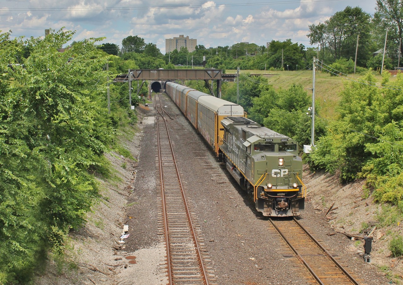 After a long wait caused by delays on the NS at Oakwood, CP 140 finally emerges from the Detroit River tunnel with the D-Day ACu solo. This train was scheduled to cross well before the high sun hours, but because of their delays the sun no longer wanted to play ball.