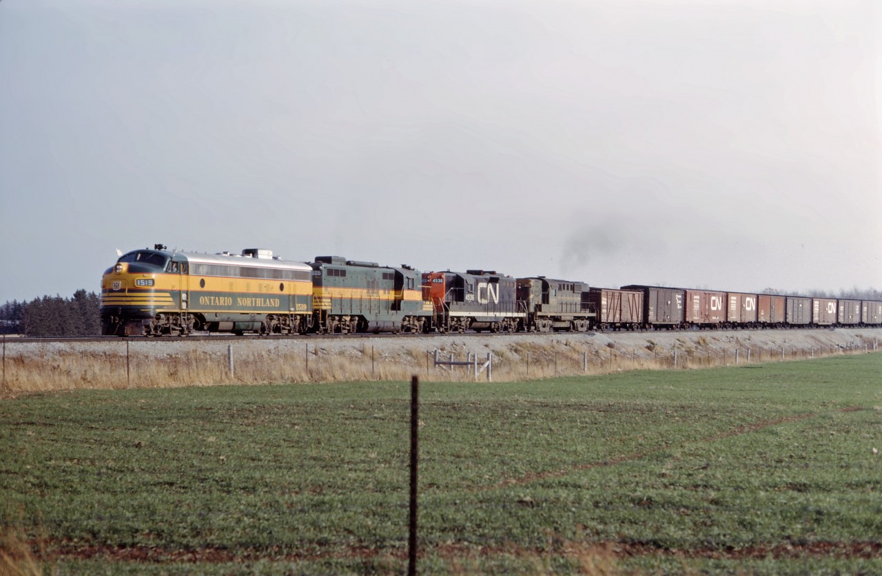 Sarnia-Toronto Yard train 496 moves up the Halton sub on a late fall day in 1966. Mr. Mercer tells me that the first three units had gone west to Sarnia the night before on train 831, with the RS18 added for the return trip. Consist is Ontario Northland FP7 1519, GP9 1605, CN GP9 4536, and RS-18 3724.