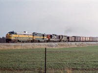 Sarnia-Toronto Yard train 496 moves up the Halton sub on a late fall day in 1966. Mr. Mercer tells me that the first three units had gone west to Sarnia the night before on train 831, with the RS18 added for the return trip. Consist is Ontario Northland FP7 1519, GP9 1605, CN GP9 4536, and RS-18 3724.