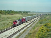 CP train #521 (USA-Toronto)seen here just out of the canal tunnel westbound to Welland Yard, where it will work, returning from the US of A via the old steel arch bridge. Power up front is SOO 767, HELM 6367 and CP 3025. Back in those crazy days of heavy leasing by the power short CP, you never knew what to expect. Image shot on ISO 400 Kodak medium format print film, 500 - 5.6 for those who care about such matters.
