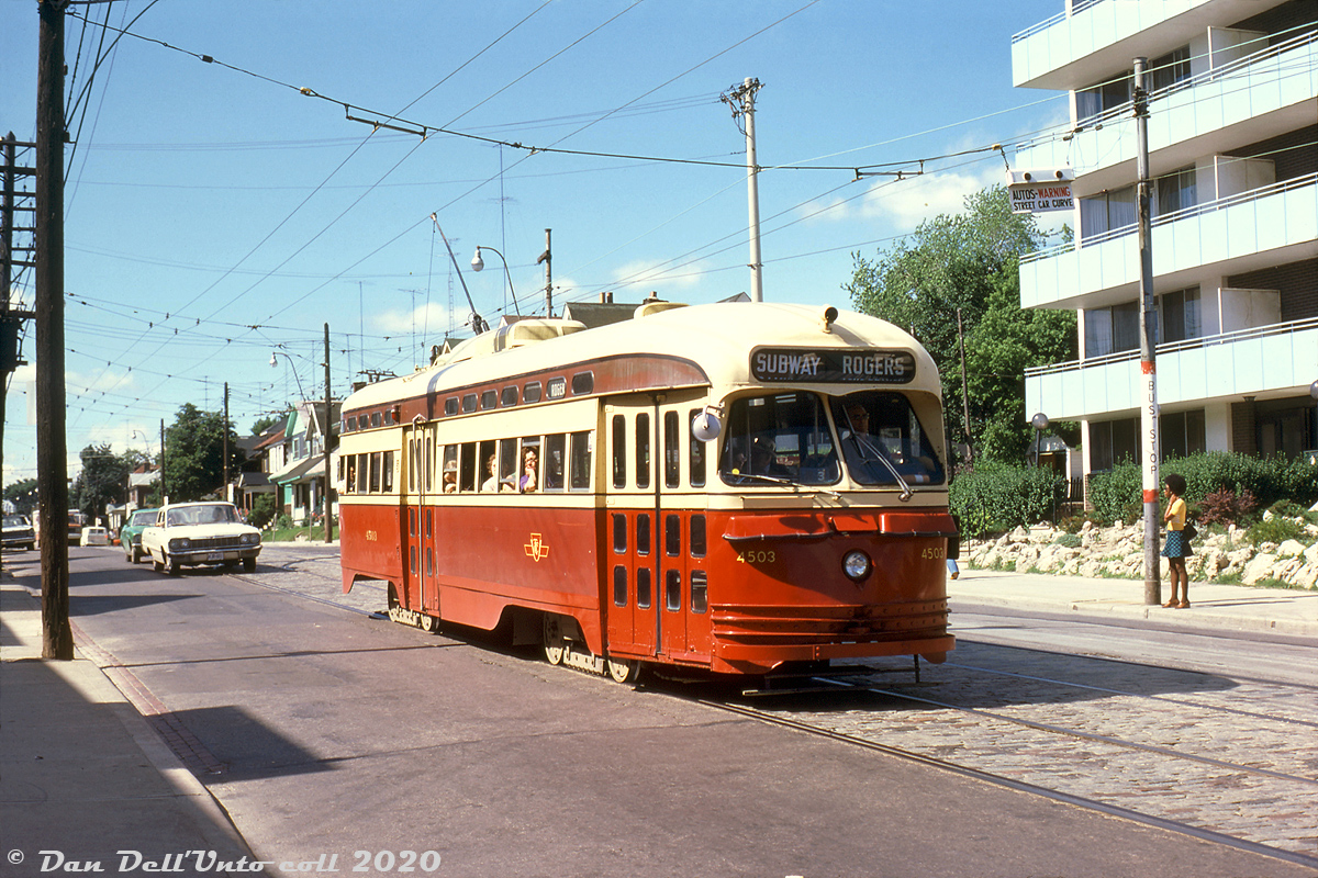 A warm summer's day out finds TTC PCC 4503 (an A8-class car built by CC&F in 1951, the newest PCCs in the fleet) heading southbound on Oakwood Avenue in service on the Rogers Road route, passing a young woman waiting at the stop opposite for a northbound Rt.63 Ossington trolleybus. The Rogers Road streetcar service had but weeks until its final day of operation on July 19th, and subsequent replacement with trolleybuses.

The US-based Electric Railroaders Association held their convention in Toronto on July 5-6-7th 1974, and many visiting and local transit/rail enthusiasts (including Tom Dorsey, a US-based transit photographer) attended a series of fantrips organized over the three day period, including one using two TTC trolleybuses (on July 5th), a GO Transit fantrip over parts of CN (July 6th), and a multiple TTC PCC streetcar fantrip (July 7th).

Tom Dorsey photo, Dan Dell'Unto collection slide.

(A photo by Robert McMann along St. Clair on the same day: http://www.railpictures.ca/?attachment_id=40006).