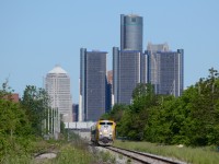 VIA train 72 just left Windsor Station, and is rocking back and forth on the mainline, with the GM Renaissance Center in Detroit Michigan in the background.