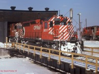 One to cool you down during this hot and humid July 2020.

  CP 5511 is being used to hostle 4700 either into or out of the Windsor roundhouse.  Sometimes during cold weather, the big-un's air starters would freeze up so they would shove them into the house for a warm-up. 
  CP5552-4706 in the background are sitting on the fuel/sand track.  

