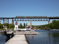 Sometimes it just all seems to come together.  June 17 was one of those days.  A tip that VIA was running an equipment extra west with 5 units and 25 cars was enough to get the adrenaline going and its timing made the Parry Sound bridge a good prospect. After spending an hour seeking the perfect spot, I gained permission to be on a dock which was actually closed to the public due to Covid 19. A couple of "heads up" contacts advised 011 had been stabbed for 55 minutes getting out of Toronto. That was actually beneficial as it gave the sun more time to be in the perfect position.  Indeed, when 011 showed up, there was perfect light, a gorgeous sky lacking contrails or cloud and no seadoos churning the water. The 5 units running elephant style with none of them "wrapped", could not have been better. Yup, sometimes it does come together.         