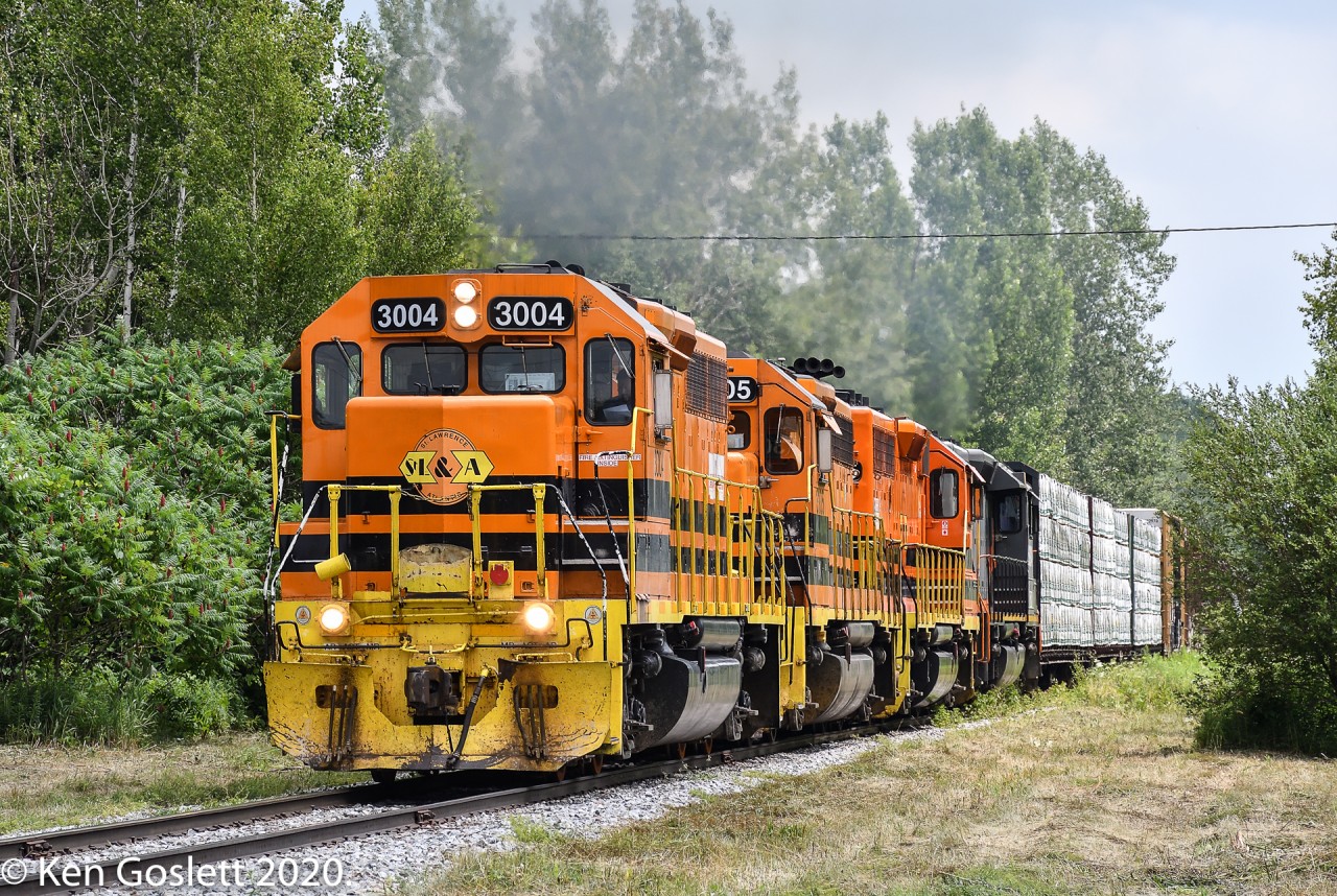 Climbing the hill to St Liboire on the former Grand Trunk mainline train 393 is midway through its journey from Richmond, QC to CN's Southwark yard near Montreal.  The four units are working hard with 84 cars in tow.