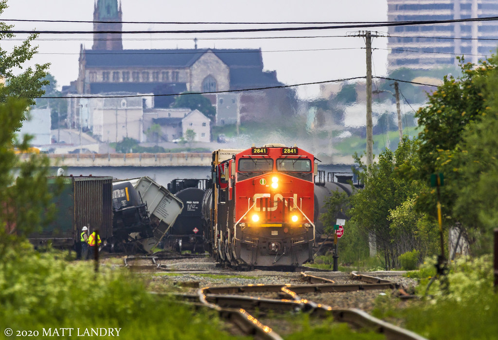 On June 20, train 406 derailed 8 cars while entering Island Yard in Saint John. The following morning, they're finally leaving town, see here in the east end of the city, passing by the derailment site.