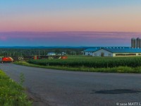 A pair of SD70M-2's lead train 406 along the farmers fields at Boundary Creek, New Brunswick at sunset. A perfect shot to show what southern New Brunswick is like. 