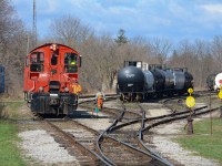 Part of the three man crew, the conductor on today’s “Cayuga Clipper” heads towards the switch in the middle of CN’s St Thomas Yard to realign it for opposite movement so they can sort out the cars they need for Aylmer, Tillsonburg, and Courtland Agromart. This would be their 4th last run, the last day the pups were on the Cayuga Sub operating this movement, and to top it off, that hopper in their cut on the right was the last car to ever be spotted at Courtland so even 21 days before cancellation, things were fading to an extent. 