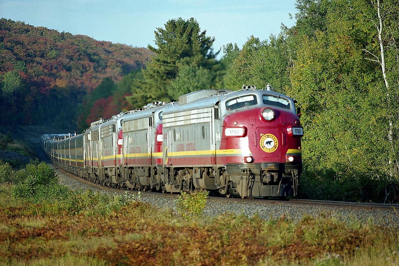 I was surprised how fast that Algoma Central tour train moved along once it got rolling. It is still rather early morning light as it banks into the curve heading northward past a railroad location called "Northland" which is about 6 miles out of Searchmont. The former days of some really nice power made this visit a pleasure every time. Today AC 1750, 1756, 1754, 1755 and 1751 are up front of around 25 coaches; a scene never to be repeated as far as train length is concerned. I have been back but once since they threw old CN units on it. And even that turned out to be an 11 hour marathon because with CN, the freights had the right of way.