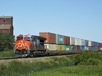 CN 3241 heads an eastbound intermodal past the old Killearn Farms elevator on the Wainwright Sub.