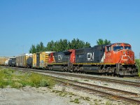 SD 75I CN 5740 and Dash 8-40C CN 2118 (ex UP) head south on the Camrose Sub at East Edmonton.