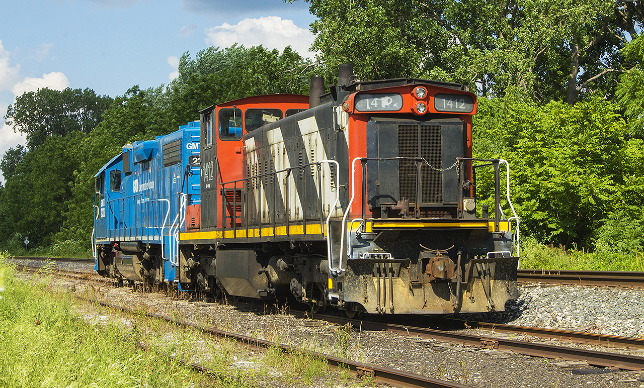 It's not everyday, that you go out for a drive and suddenly see an old yet familiar face. This is exactly what happened one Saturday afternoon, as I came across this relic and a blue GMTX unit parked in the siding at Keil Drive. Panicked, I ran home to get the camera and returned to shoot these two units, both power for the local run of 514. My thinking was that both units would be picked up by that evening's 438. Thankfully, the sun stayed out just long enough and as of today (a week later) I have been notified that it does not appear that 514 has run yet. And these two units are still parked in the same location. Nonetheless, happy to have started off my vacation this way, even if the walk in was a little thorny to say the least from all the track side overgrowth!!