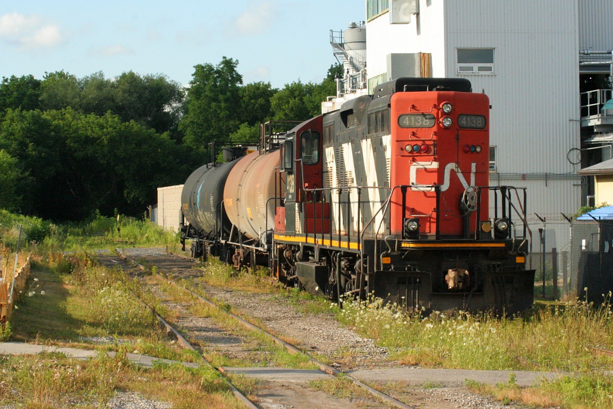 Over two decades later the Waterloo Spur is a much different place now being owned by the Region of Waterloo and is a large component of the new ION light rail system. After servicing the line for 20 years, the Goderich-Exeter Railway’s lease of the Guelph Subdivision and related spurs wasn’t renewed, thus CN returned in November 2018. Now, ordered as required for 21:00 CN L566 services Elmira during the week operating on the shared ION trackage during a small window over night. The CN assignment has to be off the ION operated section before the light rail schedule begins to roll again in the early morning hours. However, sometimes the job doesn’t make it back due to any number of factors and ends up timing-out on the line between Elmira and Northfield Drive in Waterloo. 


On July 30, 2019 it was reported that CN L566 had ran out of time that morning in Elmira with none other than 4138. The unit and two tankers would sit near the former Uniroyal plant, now Lanxess, for most of the day and evening awaiting a fresh crew to take L566 back to Kitchener later that night. There was no question that after work that day, Elmira was my destination. Now 26 years later, I still felt the same excitement as I had the day of my first cab ride. This time it was the anticipation of once again seeing CN 4138 on the Waterloo Spur so many years later. Upon arrival in Elmira I saw it had its CN noodle proudly re-applied on its long hood exactly as it did in 1993. For a brief period I was that 13-year-old kid again as I photographed 4138 in the same evening lighting as that summer day so long ago. And the best part was that I was able to share it with my wife and young daughter who had come with me. I wasn’t  going to take any chances as this time ensuring that all the images were saved on my SLR camera’s memory card…..and on my phone and my wife’s phone, which they thankfully all were. Checked, double-checked and triple-checked….